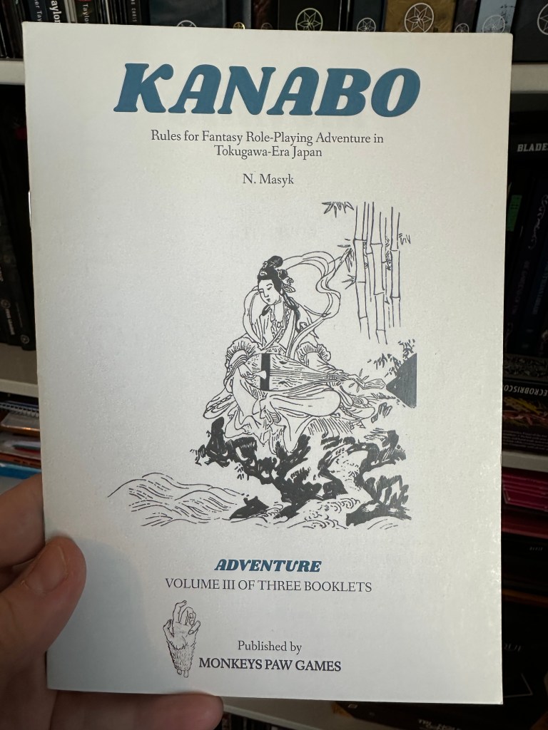 The cover of Kanabo Volume 3, Adventure. It shows the image of a woman, or maybe a bodhisatva playing a shamisen on the edge of a cliff. 