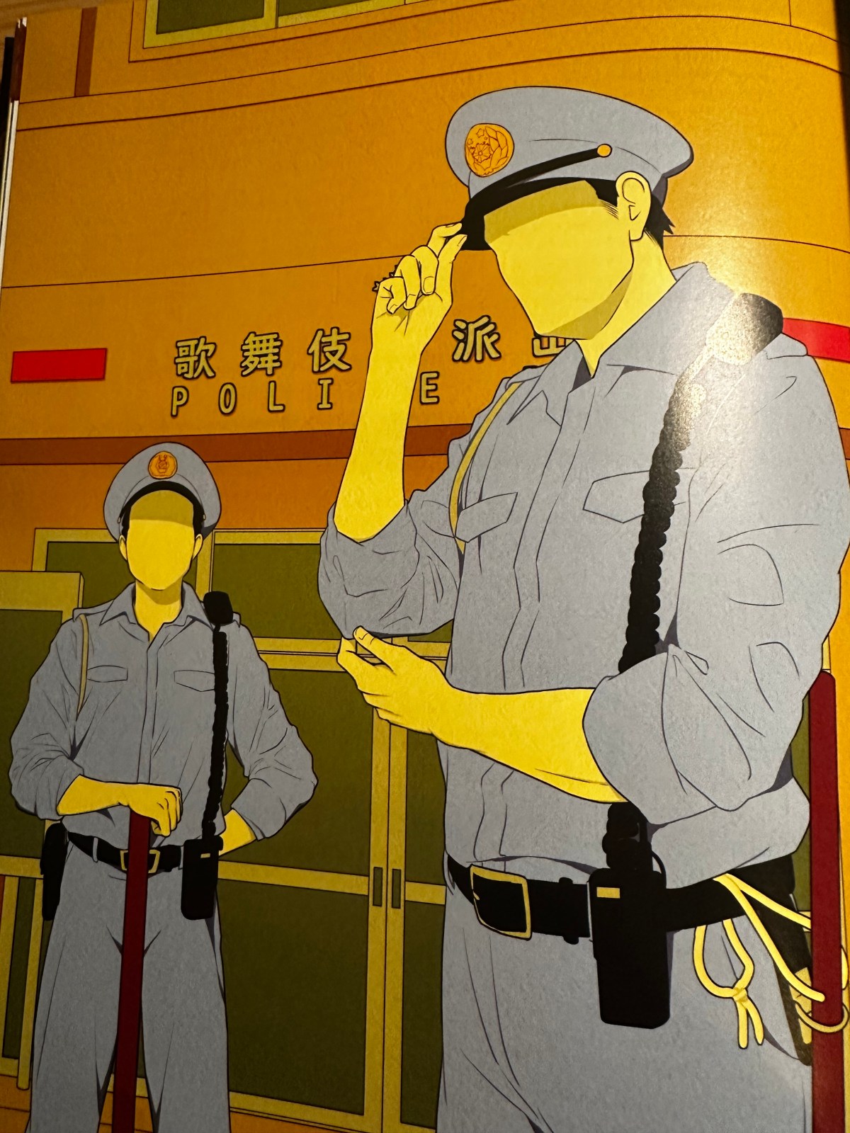 Two police officers, uniformed, but with no features on their faces, pictured in fromnt of a police box