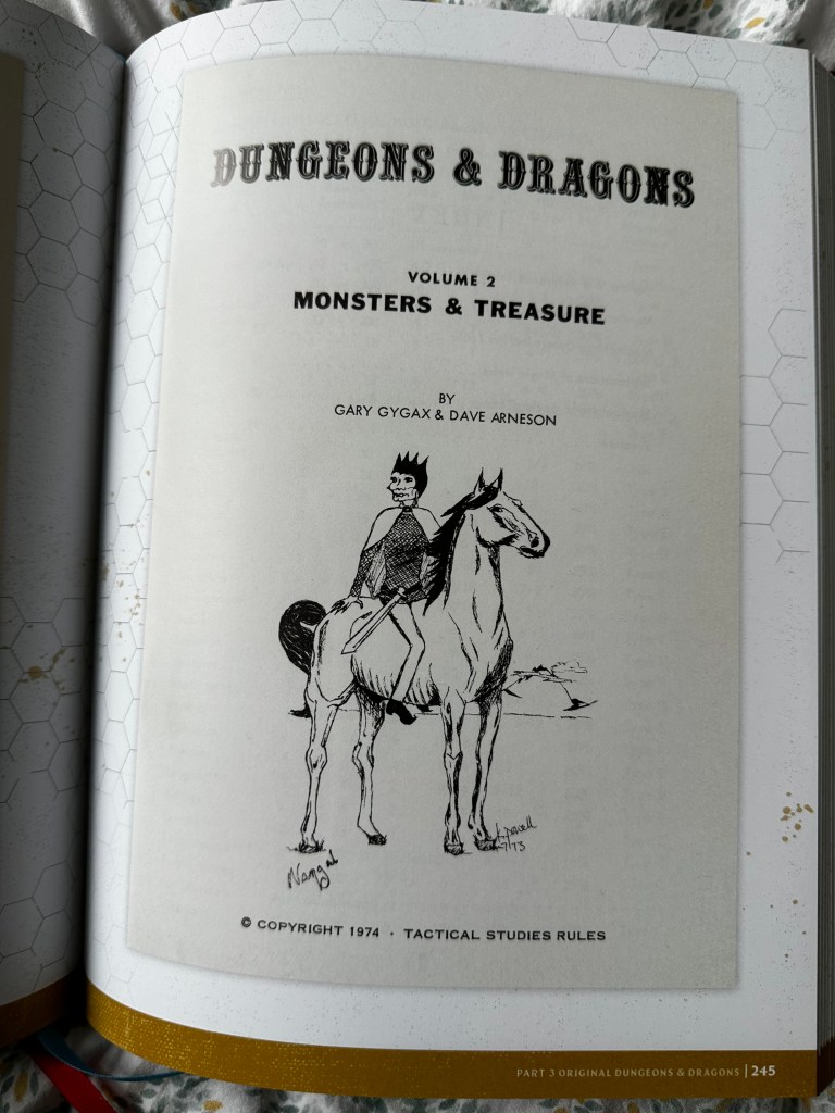 OD&D Volume 2, Monsters & Treasure. There is a guy astride a horse with a sword and a crown on the cover.
