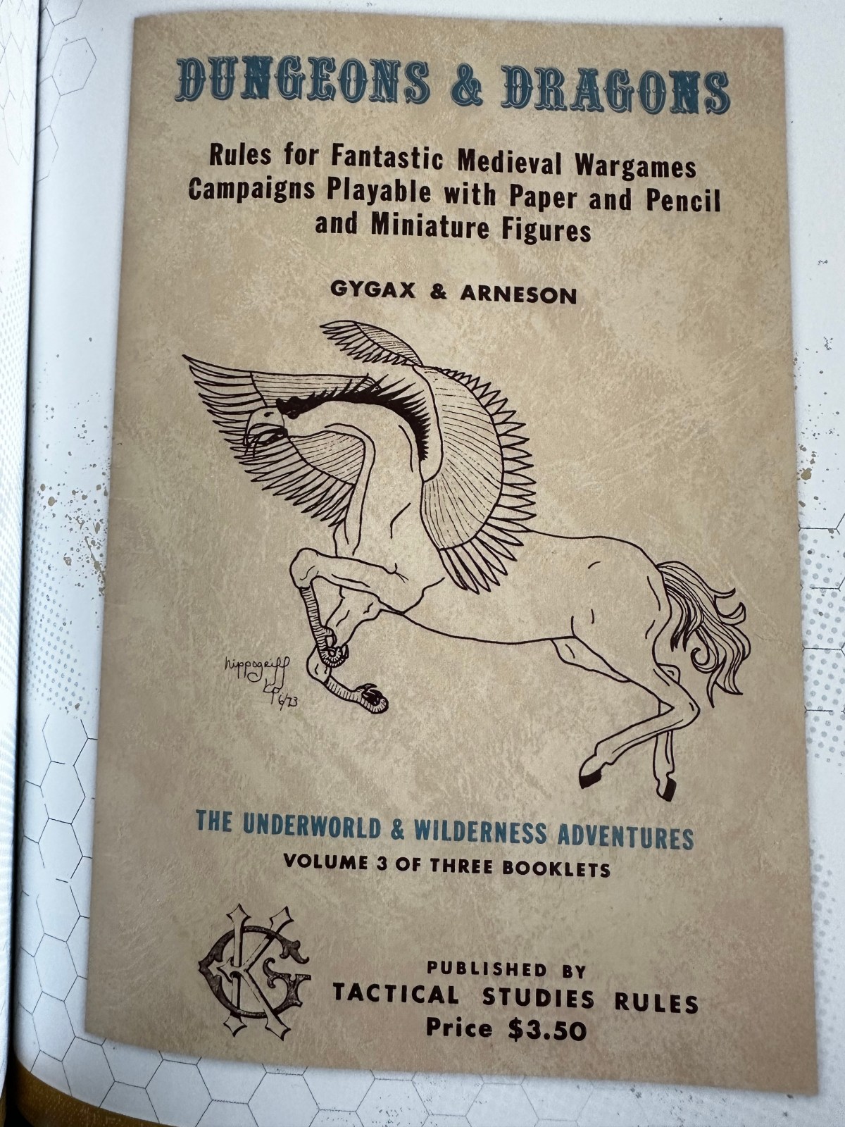 The original fornt cover of OD&D Volume 3, Underworld & Wilderness Adventures. It sports an amateurish hypogriff.