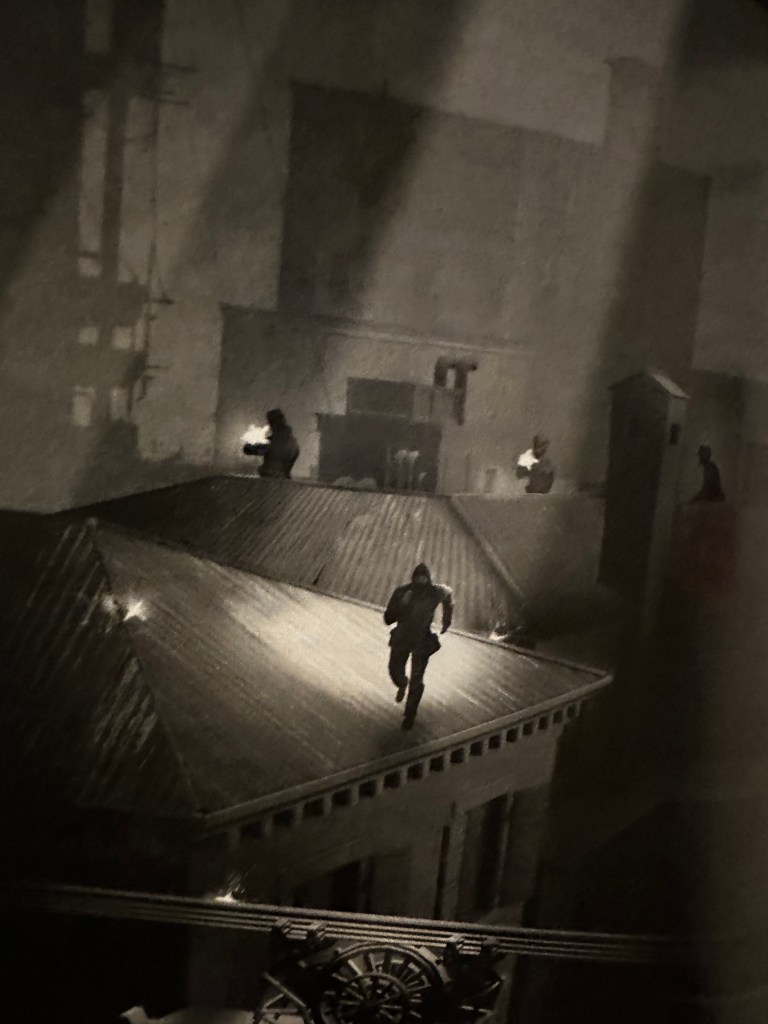 Light shines down from above on a scoundrel running acorss the rooftops of Doskvol