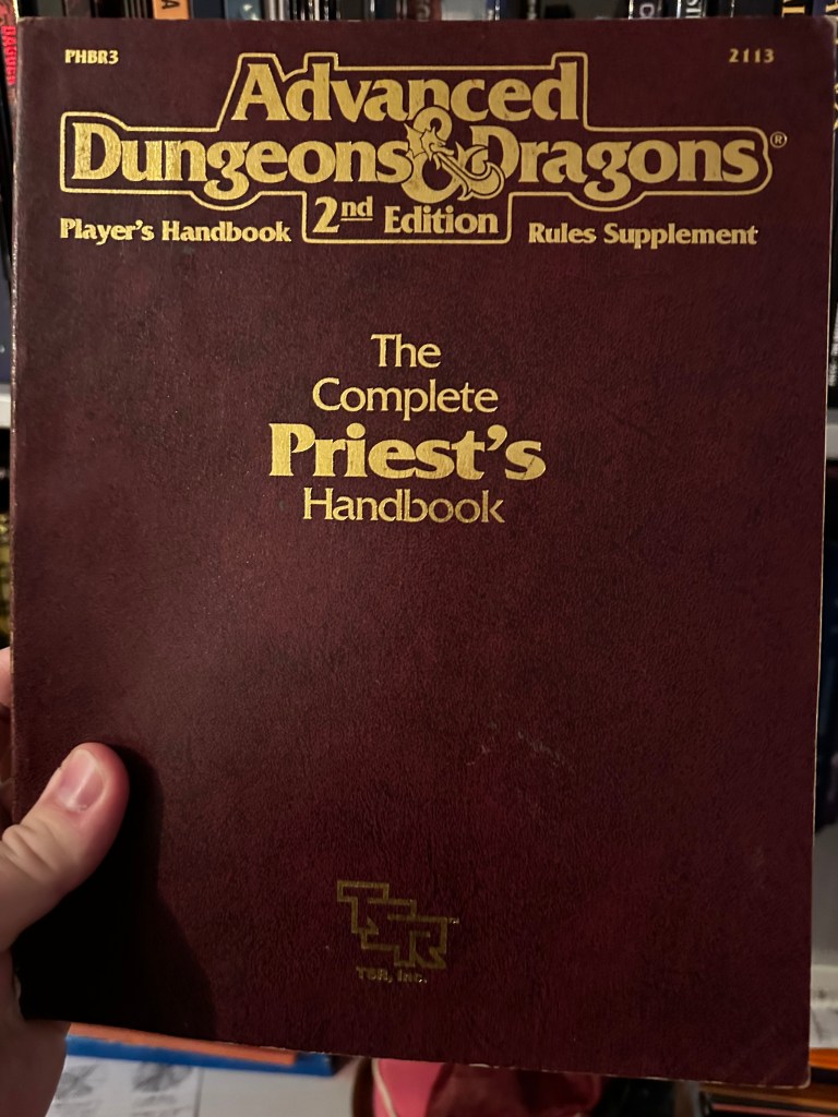 Cover of the Complete Priest's Handbook for AD&D 2e. It is wine in colour.