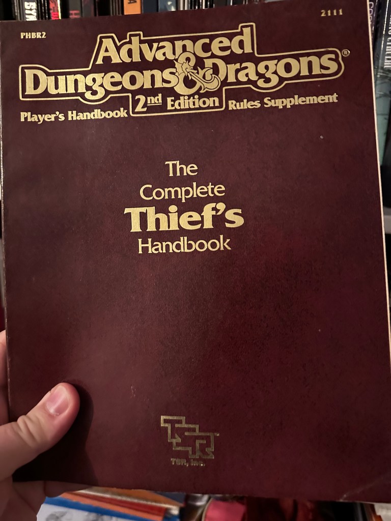 Cover of the Complete Thief's Handbook for AD&D 2e. It is wine in colour.