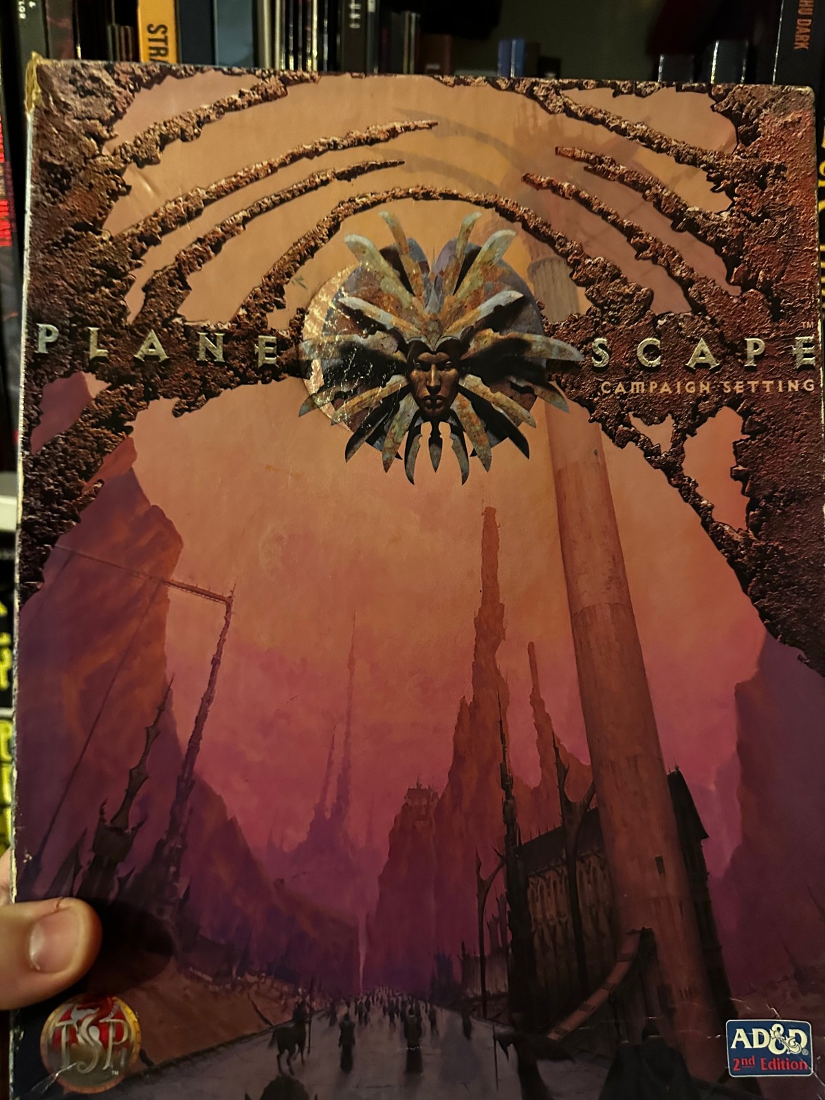The cover of the AD&D 2nd Edition Planescape Boxed Set showing a road in the Outlands that leads to the infinite spire atop which floats the city of Sigil