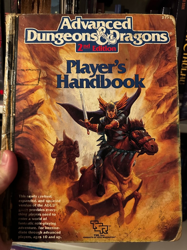 AD&D 2nd Edition PHB cover. Its got a horseman on it. He has a sword.