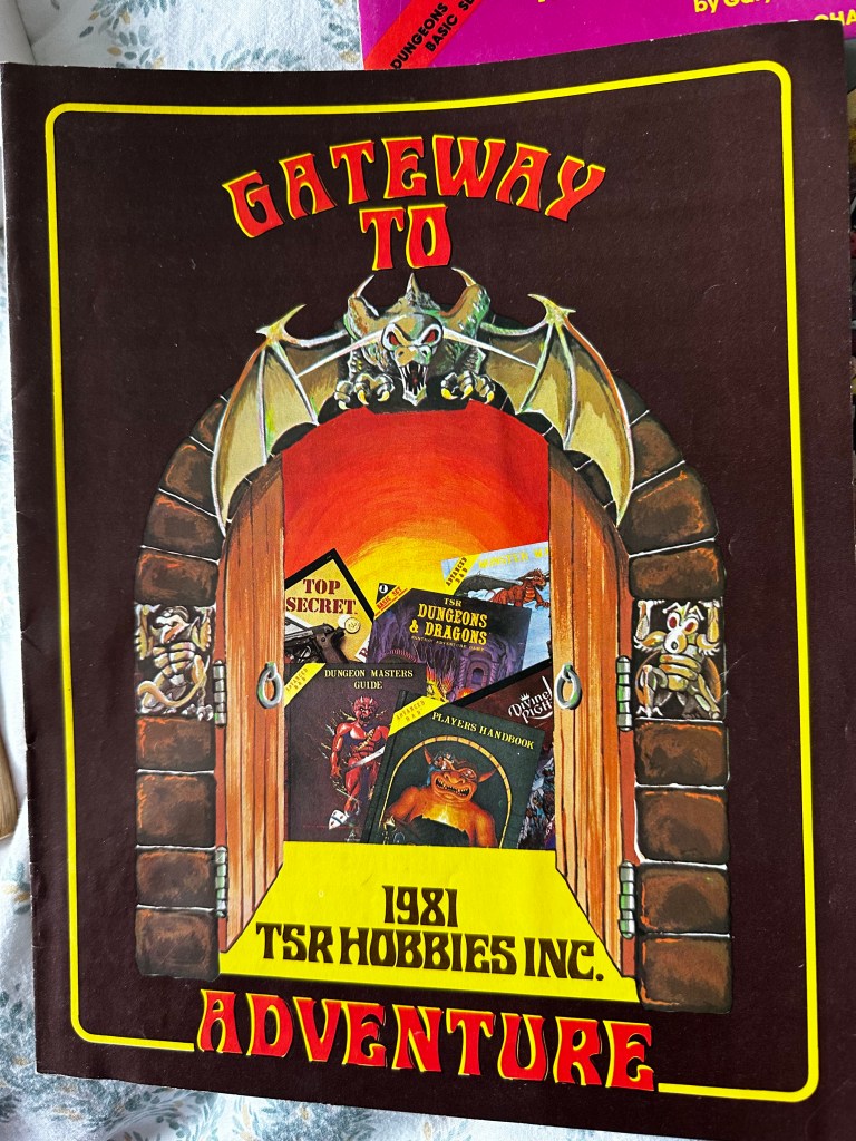 Gateway to Adventure, the TSR product catalogue inside the boxed side. The brown cover has a mysterious stone doorway beyond which lurks the covers of various TSR books.