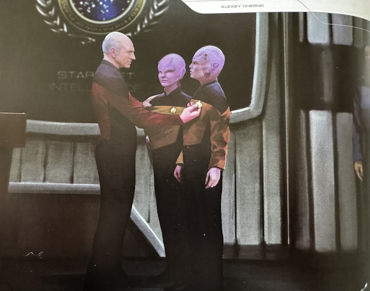 Captain Picard promoting a pair of Bynars