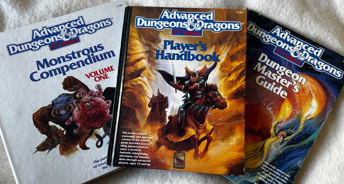 The covers of the AD&D 2nd Edition Monstrous Compendium, Player's Handbook and Dungeon Master's Guide
